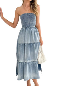 Woman wearing a strapless denim dress against a white background